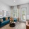 bedroom with blue couch and furniture.