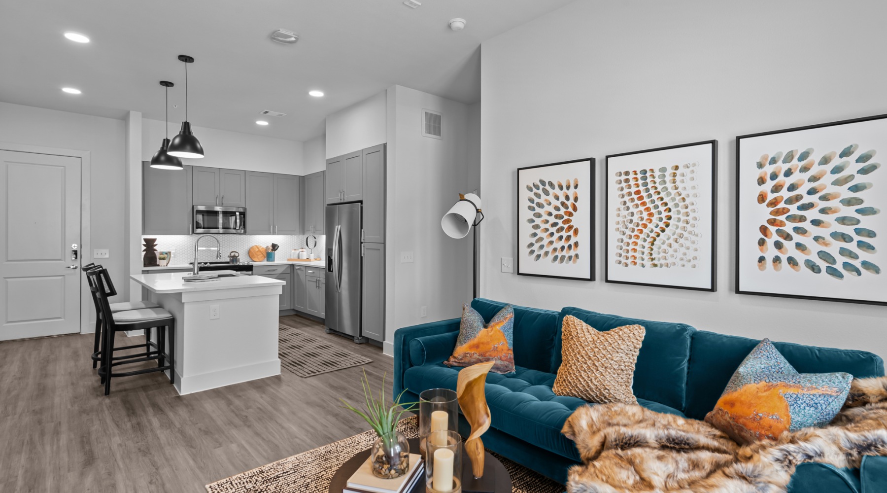 Living areas that elevate your lifestyle a living room with a couch next to a kitchen