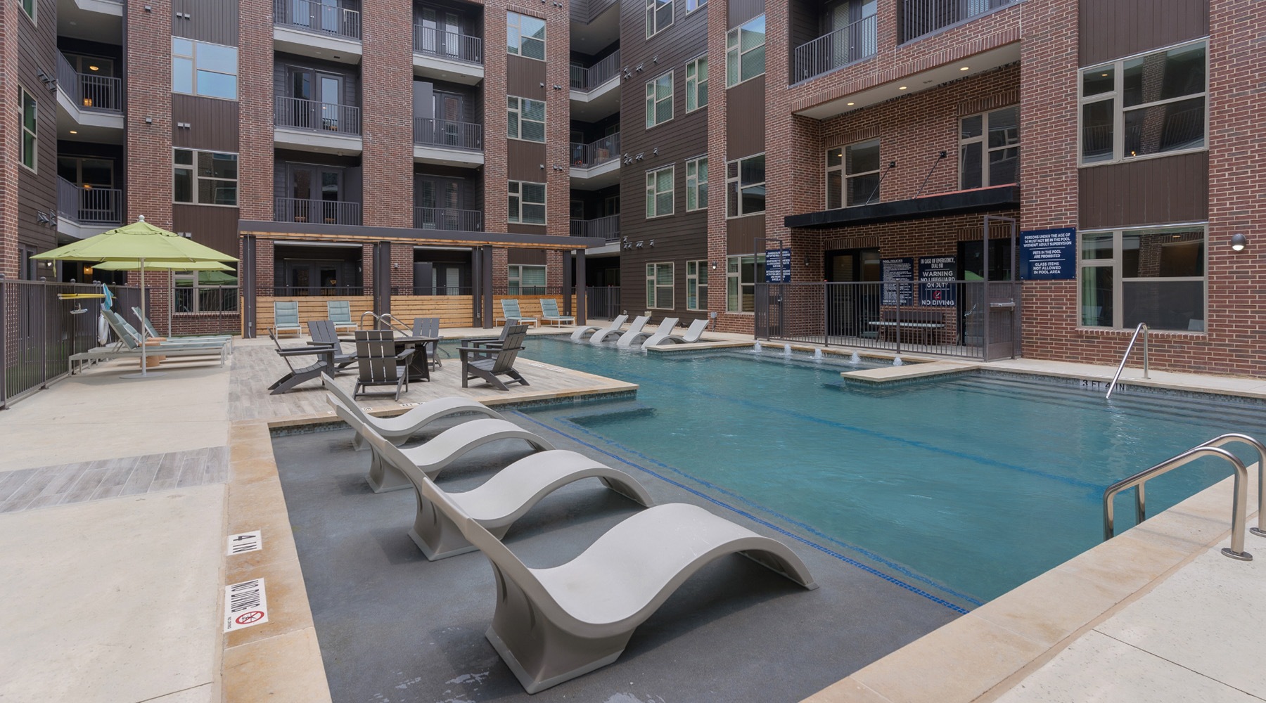 Resort style swimming pool a swimming pool with white chairs